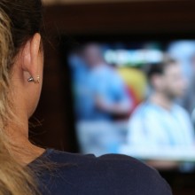 Photo of a woman, watching TV